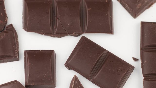 Pieces of dark chocolate on a white background isolate