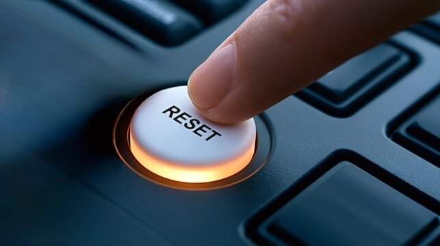 Human finger pressing a glowing white reset button, symbolizing a fresh start, system reboot, data wipe, or initiating change and control in technology, business, or life