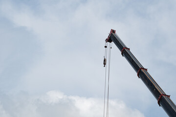 Closeup Mobile crane boom with wire ropes against blue sky  © Jira