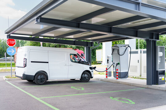 Electric commercial van charging at a modern EV charging station