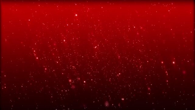 Abstract red background with falling glitter particles.