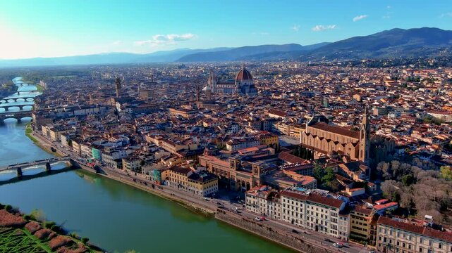 Aerial drone view of Florence with the Duomo cathedral, Arno River bridges, Palazzo Vecchio, Santa Croce basilica and terracotta rooftops, Tuscany, Italy, on a sunny spring day.
