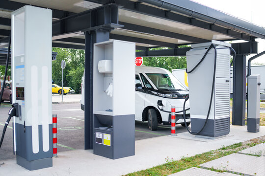 Electric commercial van charging at a modern EV charging station