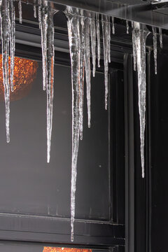 MONTREAL, CANADA, 25 December 2025 : Icicles hanging from building roof winter cold weather architecture urban scene