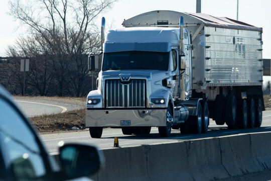 Quebec, Canada, 24 April 2026 : A white Western Star semi-truck with a silver trailer drives on a highway.
