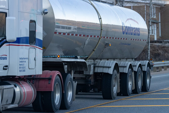 Quebec, Canada, 24 April 2026 : A Contrans semi-truck with a large tanker trailer drives on a road.