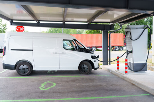 Electric commercial van charging at a modern EV charging station