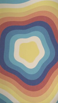 Vibrant 70s-inspired abstract animation with colorful wavy lines forming a blobby flower pattern. Retro psychedelic design with fluid motion for entertainment and creative projects.
