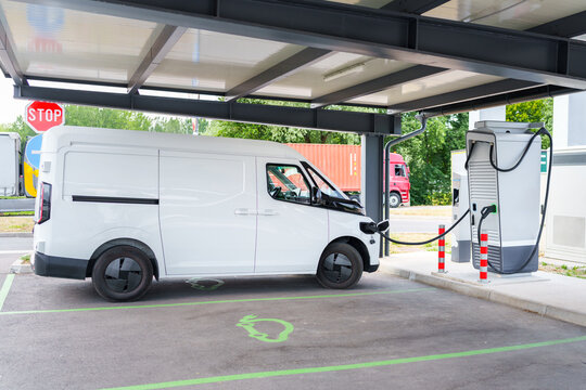 Electric commercial van charging at a modern EV charging station