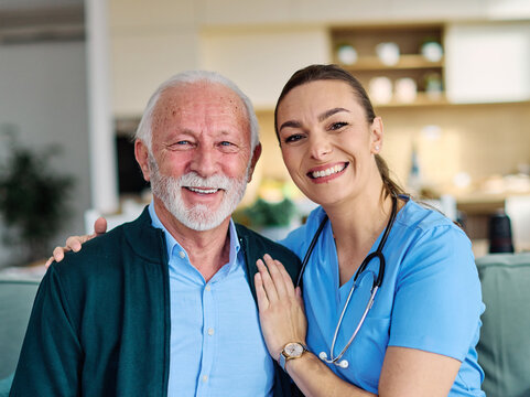 Portrait of a doctor or nurse caregiver with  senior man at home or nursing home