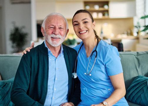 Portrait of a doctor or nurse caregiver with  senior man at home or nursing home