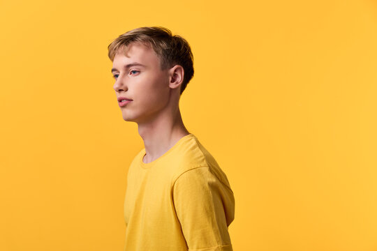 Yellow shirt male side profile in a studio setup, fashion orientated image with casual style, clean lines and minimal composition, emphasizing confidence and modern appeal for lifestyle, advertising