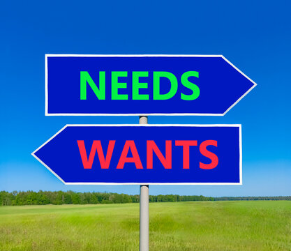 Needs instead wants words symbol. Concept words Needs Wants on beautiful blue road sign. Beautiful blue sky background. Business psychology needs or wants concept. Copy space.
