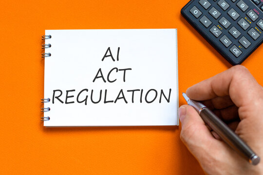 AI act regulation words symbol. Concept words AI artificial intelligence act regulation on beautiful white note. Beautiful orange background. Business AI act regulation concept. Copy space.