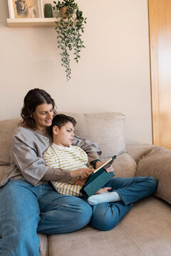 Mom and child with cerebral palsy enjoying tablet