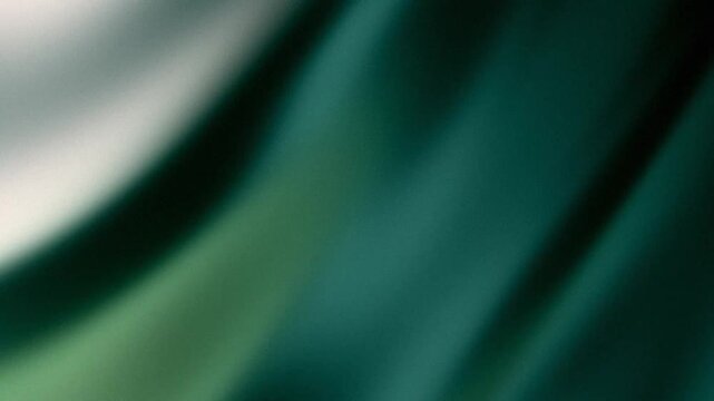 Dark green silk fabric background with elegant folds and soft light