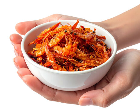 Hands presenting a white porcelain bowl filled to the brim with dried salted orange seafood shrimp ebi on white