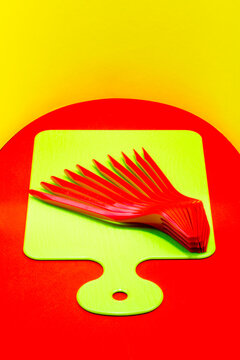 Cutting board with plastic forks on a red table