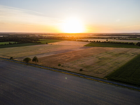 Aerial View of a Country Road through Farmland at Sunset in Germany
