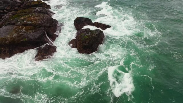 Top view of Ocean waves crashing and foaming on the rocks. Sri Lanka.