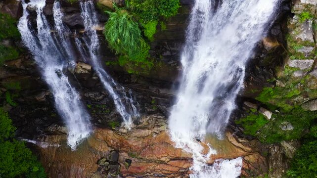 Aerial view of Lower Ramboda Falls in green forest. Waterfall in the tropical mountain jungle. Sri Lanka.