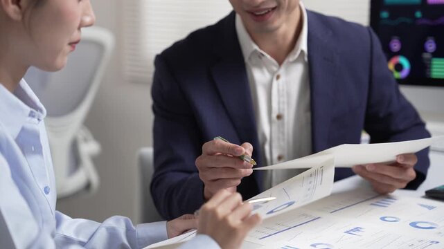 Business people working together and reviewing financial documents in an office