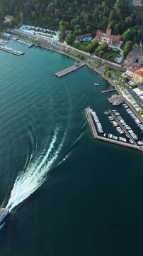 Ferry departing from Garda pier, aerial view. Public transport stop on intertown Garda lake service