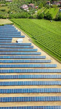 Aerial view of photovoltaic panels in Italian vineyard area. Integration of clean energy in the energy transition strategy