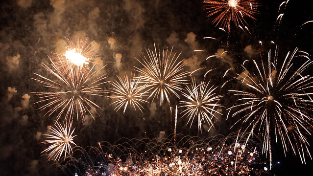 Amazing real beautiful colorful fireworks background on celebration night event for happy new year party, independence day, festivals, Abstract Multi color golden firework in the night sky
