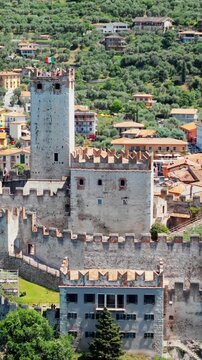 Scaliger Castle on cliff in Malcesine, Lake Garda. Medieval fortress with stone walls and central tower in Italy