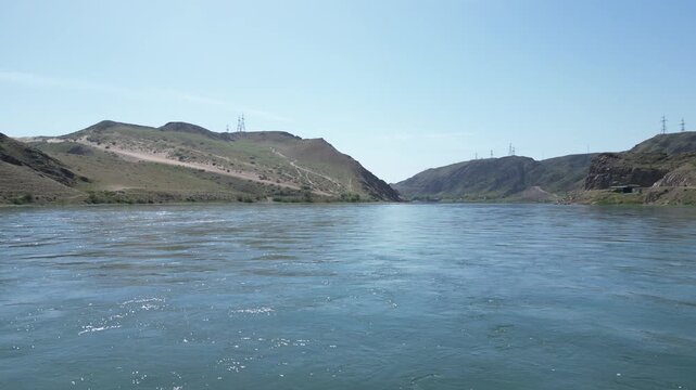 Aerial flight over the Ili River in the mountains of Kazakhstan