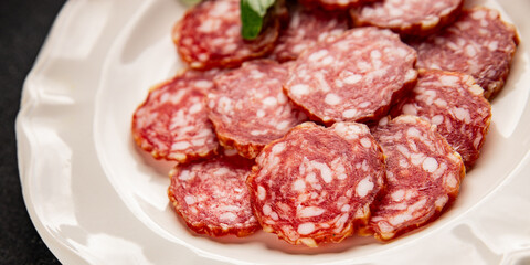 Obraz premium Sausage slices salami cured sausages meat food preparation dish tasty snack fresh and delicious gourmet rustic food background on the table&nbsp; rustic food top view copy space