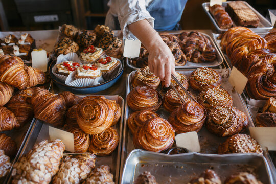 Assorted pastries and cinnamon rolls at a bakery counter