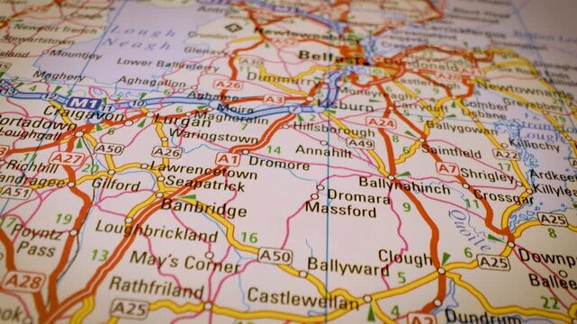 road network to belfast, northern ireland, gliding macro view over atlas map