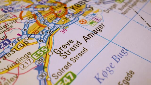 road network to copenhagen, denmark, gliding macro view over atlas map