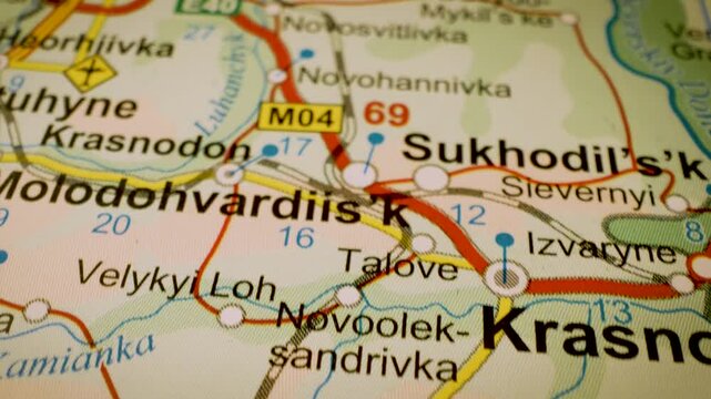 macro flight to luhansk, ukraine, across detailed road atlas map