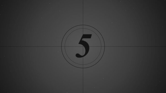 Film countdown leader with number five displayed on a dark vintage cinema screen
