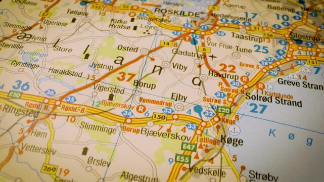 road network to roskilde, denmark, gliding macro view over atlas map