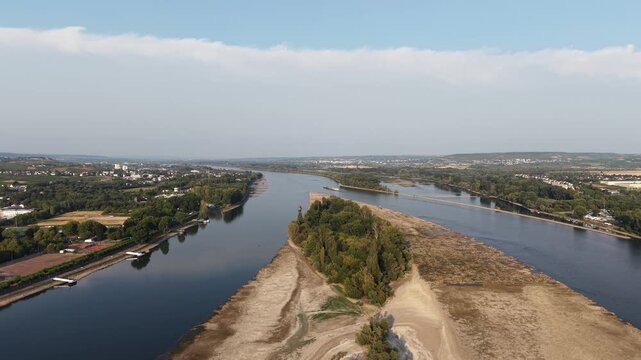 Drone aerial view of Klopp Castle hill in Bingen am Rhein, Germany, featuring the forested hillside crowned by Klopp Castle, vineyards, historic architecture and the Rhine riverside below. Scenic summ