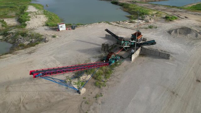 Aerial view of a rotating gravel conveyor belt at a quarry and stone crushing plant