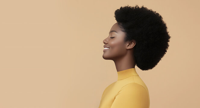 Serene young Black woman with natural afro hairstyle smiling with eyes closed