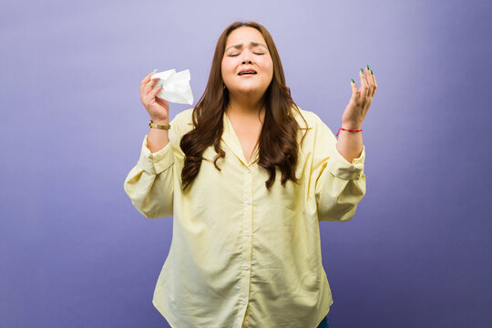 Overweight woman feeling sad and crying, experiencing grief, dealing with emotional problems and sorrow