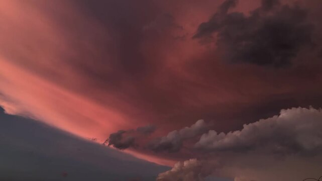 Vibrant sunset clouds paint the sky in hues of pink and purple, evoking a sense of awe and tranquility