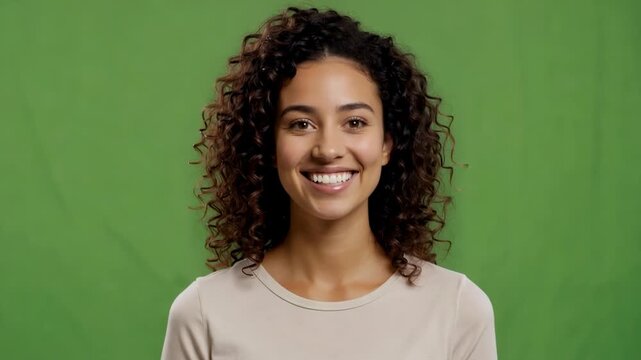 Young Woman Smiling Confidently During Studio Portrait Session with Green Screen Background