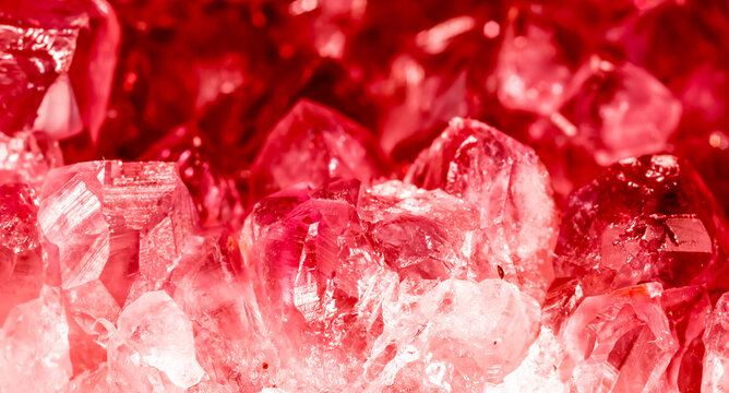 Amethyst red crystals. Gems. Mineral crystals in the natural environment. Texture of precious and semiprecious stones. Seamless background with copy space colored shiny surface of precious stones.