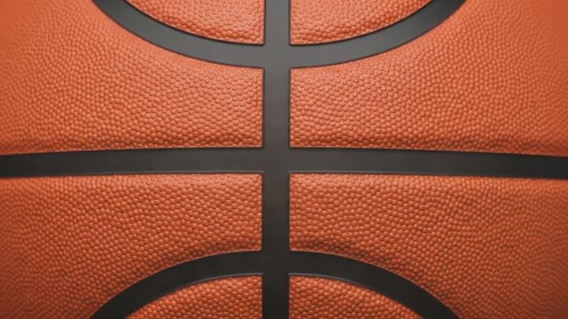 Close up basketball surface texture with black lines rotating smoothly