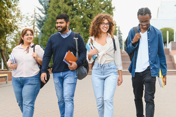 Fototapeta premium Diverse students walking on university campus together