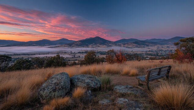 Sunrise view from a hilltop with a bench