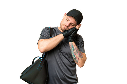 Young sport man with sport bag over isolated chroma key background making sleep gesture in dorable expression