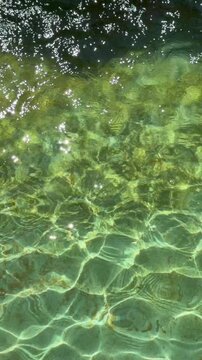 Clear swimming pool water surface rippling